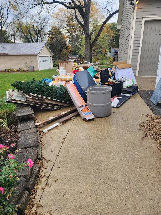 Dumpster being loaded with debris for Roofing Dumpster Rental in Forsyth